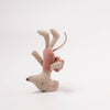 Stuffed animal toy with pink body and beige antlers on a white background